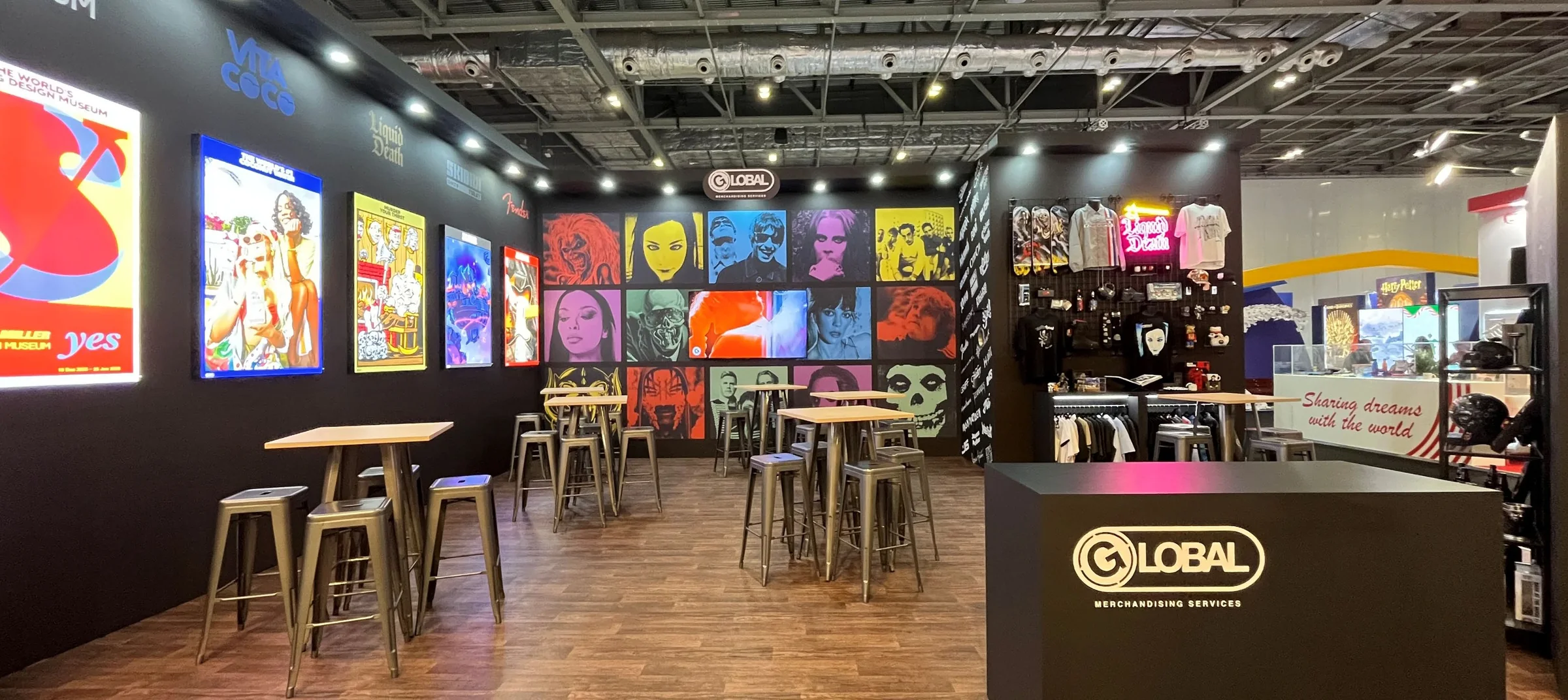 Global Merchandising Services exhibition stand at BLE 2026, with colorful artist portraits, framed artwork and merchandise displays.