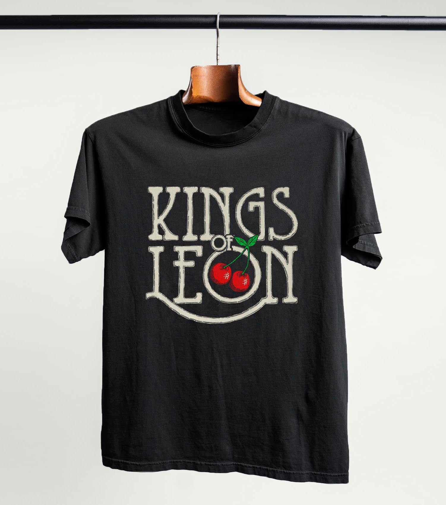 Official vintage black Kings of Leon Retro Cherries T-shirt, with cream lettering and red cherries.