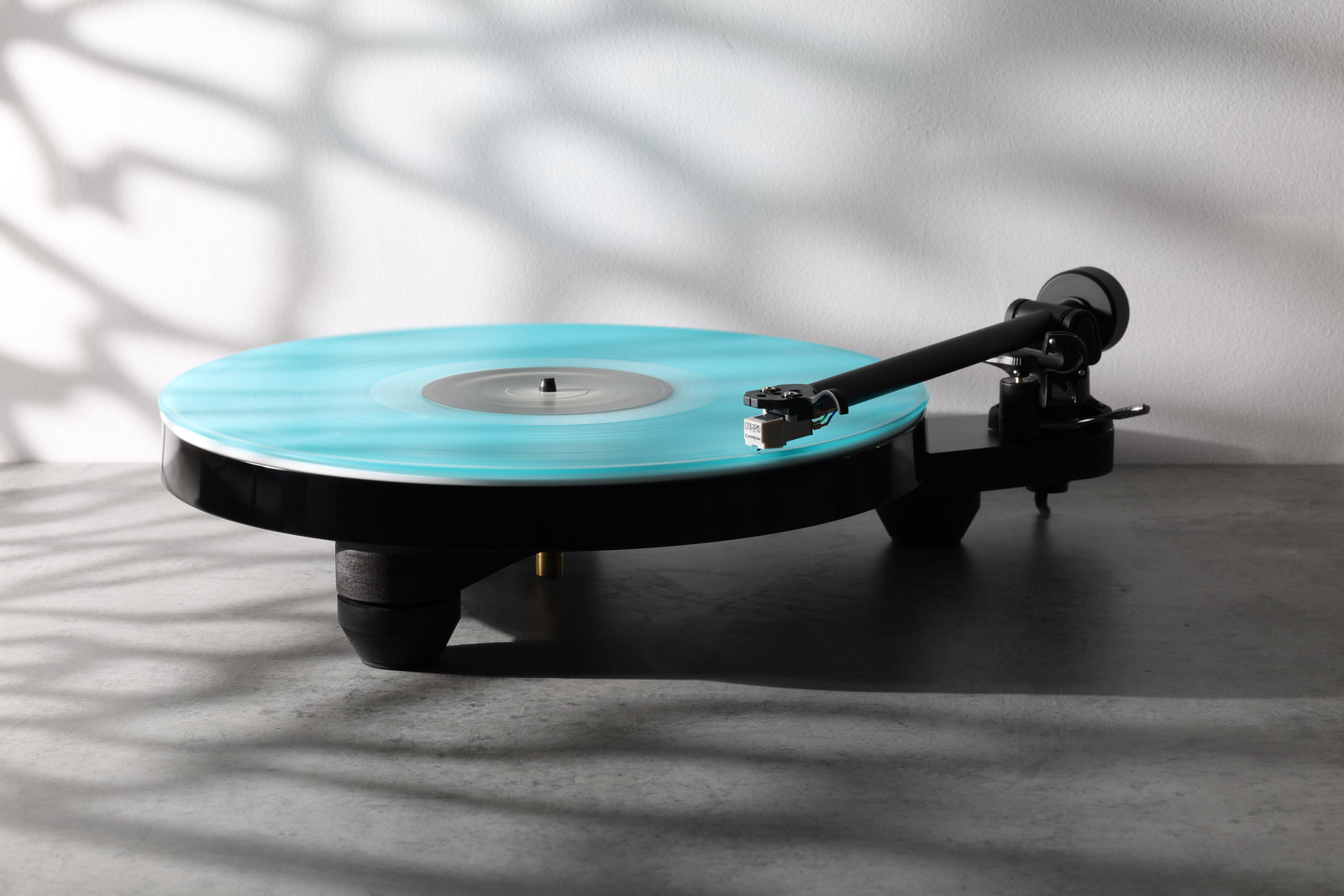 A black turntable with turquoise vinyl, from Supervinyl’s audio selection